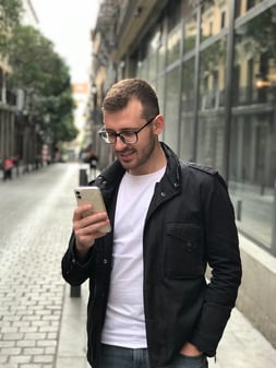 A man looks at his crypto earnings on his phone